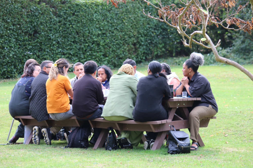 Attendees sat on a bench discussing mission and ministry
