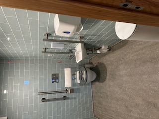 accessible toilet with grey station tiles