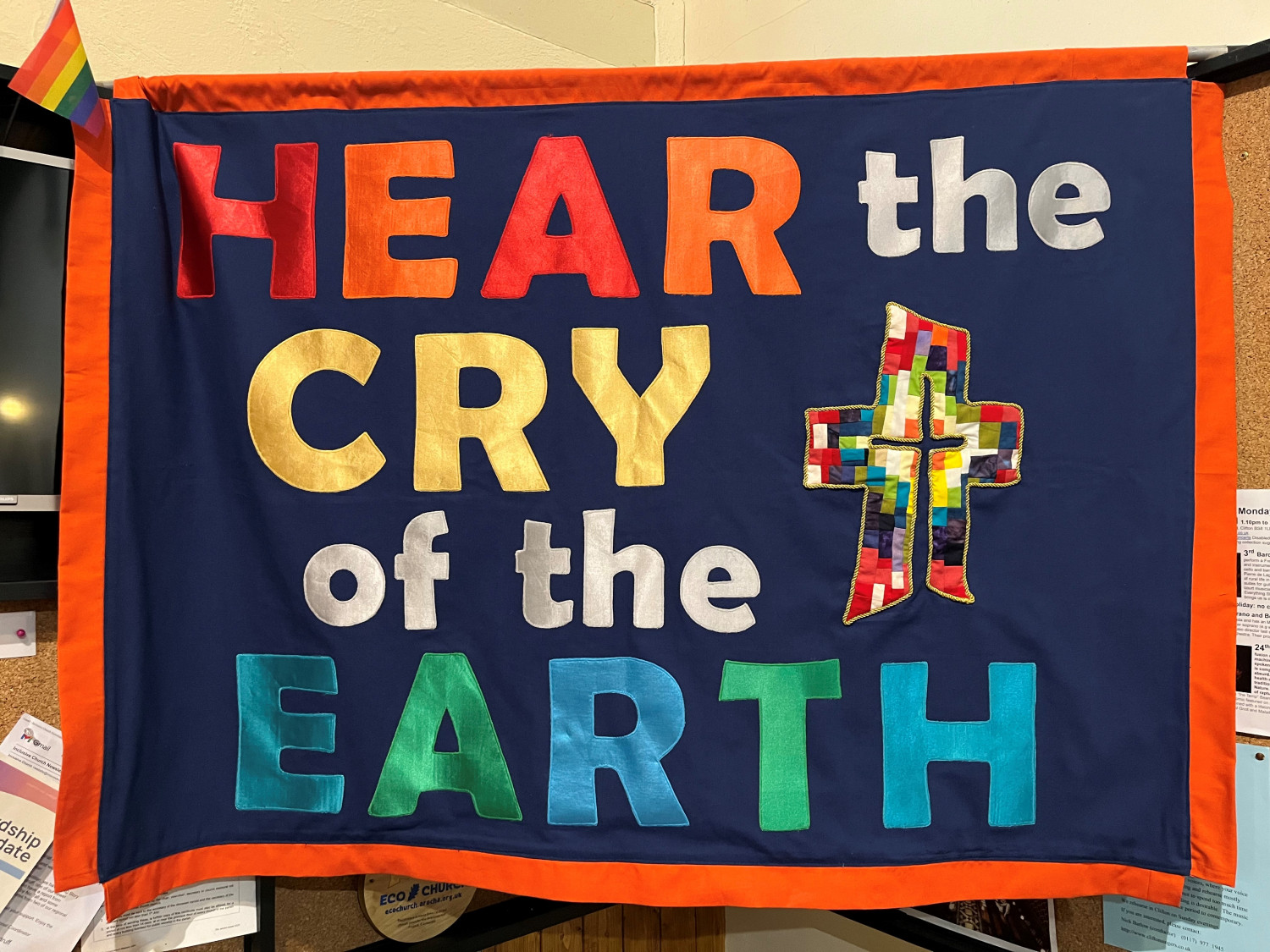 Hand sewn hear the cry of the Earth banner, in rainbow colours